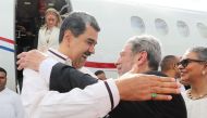 This handout picture released by the Venezuelan Presidency shows Venezuela's President Nicolas Maduro (left) greeting Prime Minister of Saint Vincent and the Grenadines Ralph Gonsalves after arriving at the Argyle International Airport in Saint Vincent and The Grenadines on December 14, 2023. (Photo by Zurimar Campos / Venezuelan Presidency / AFP)