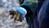 Former forest ranger Jose Antonio Soriano holds a black truffle, freshly harvested by himself, with help of his dog Pista, from the grove he owns in Sarrion, eastern Spain, where oak trees live in symbiotic relationship with the truffle producing fungus, on December 10, 2023. Photo by JOSE JORDAN / AFP