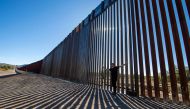 Laiken Jordahl, Southwest Conservation Advocate, makes a video in front of a section of the US-Mexico border wall in Sasabe, Arizona on December 8, 2023.  (Photo by VALERIE MACON / AFP)