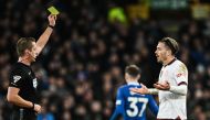 Manchester City's English midfielder #10 Jack Grealish (R) reacts as he receives a yellow card during the English Premier League football match between Everton and Manchester City at Goodison Park in Liverpool, north west England on December 27, 2023. (Photo by Paul ELLIS / AFP