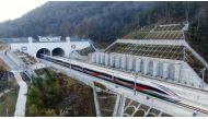 This aerial photo shows a train departing from Yixian East Railway Station in Huangshan City, east China's Anhui Province, Dec. 27, 2023. (Photo by Lyu Jinyi/Xinhua)