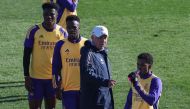 (From L) Real Madrid's French defender #18 Aurelien Tchouameni, Real Madrid's Brazilian forward #07 Vinicius Junior, Real Madrid's Italian coach Carlo Ancelotti and Real Madrid's Brazilian forward #11 Rodrygo attend a training session at the Ciudad Real Madrid training ground in Valdebebas, Madrid, on December 30, 2023. (Photo by Pierre-Philippe MARCOU / AFP)