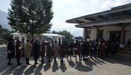Bhutanese people line up to vote at a polling station in Thimpu on October 18, 2018. Photo by DIPTENDU DUTTA / AFP