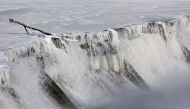 Ice forms along a dam built in the Des Moines River as temperatures remain below zero Fahrenheit on January 14, 2024, in Des Moines, Iowa. Joe Raedle/Getty Images/AFP 