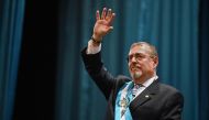 Guatemala's new President Bernardo Arevalo waves after swearing in during his inauguration ceremony at the Miguel Angel Asturias Cultural Centre in Guatemala City, early on January 15, 2024. (Photo by Johan ORDONEZ / AFP)
