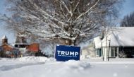 A campaign sign supporting Republican presidential candidate former President Donald Trump is stuck in the snow on January 15, 2024, in Pella, Iowa. (Photo by JOE RAEDLE / GETTY IMAGES NORTH AMERICA / Getty Images via AFP)

