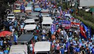 Jeepney drivers and operators march during a protest against the jeepney modernisation program in Manila on January 16, 2024. Photo by JAM STA ROSA / AFP