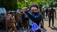 A blindfolded activist with a rope tied around his wrists and covered with logos of different social media platforms takes part in a protest against the proposed 'Online Safety Bill' on January 24, 2024. (Photo by Ishara S. Kodikara / AFP)
 