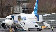 A person walks past a Boeing 737 MAX 8 for United Airlines parked at Renton Municipal Airport adjacent to Boeing's factory in Renton, Washington, on January 25, 2024. Photo by Jason Redmond / AFP