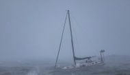 A boat moored offshore is tossed by rough waters as the second and more powerful of two atmospheric river storms arrives to Santa Barbara, California, on February 4, 2024. (Photo by David McNew / AFP)
 