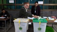 A man casts his ballot to vote at a polling station during Pakistan's national elections in Lahore on February 8, 2024. (Photo by Arif Ali / AFP)