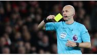 File: Premier League referee Anthony Taylor shows a yellow card. (Adrian Dennis / AFP)