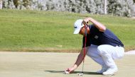 Ugo Coussaud prepares to putt in the third round of the Commercial Bank Qatar Masters at the Doha Golf Club, yesterday. 