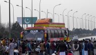 Supporters of Khan's Pakistan Tehreek-e-Insaf (PTI) party block Peshawar to Islambad highway as they protest against the alleged skewing in Pakistan's national election results, in Peshawar on February 12, 2024. (Photo by Abdul MAJEED / AFP)
