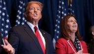 Republican presidential candidate and former President Donald Trump gestures to supporters at an election night watch party at the State Fairgrounds on February 24, 2024 in Columbia, South Carolina. Also pictured is South Carolina Lieutenant Governor Pamela Evette (R). Win McNamee/Getty Images/AFP 