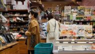 Customers gather at a souvenir shop that sells local seafood in Tokyo on February 27, 2024. (Photo by Kazuhiro NOGI / AFP)
