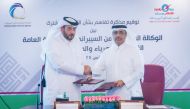 President of Kahramaa Eng Essa bin Hilal Al Kuwari (right) and President of NCSA Eng Abdul Rahman bin Ali Al Farahid Al Maliki exchanging documents after signing the agreement.