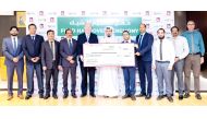 Regional Manager of Lulu Group in Qatar Shanavas Padiyath presents the cheque to Public Relations Coordinator of the QSRSN Dheyaa Khaled Alshmare.