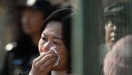 A relative of a passenger on board the missing Malaysian Airlines flight MH370 reacts during a gathering outside the Malaysian embassy in Beijing on March 8, 2024, on the 10th anniversary of the flight's disappearance. (Photo by GREG BAKER / AFP)