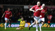 Wrexham's striker Paul Mullin (second right) celebrates scoring the team's third goal during the English FA Cup fourth round match between Wrexham and Sheffield United at the Racecourse Ground Stadium in Wrexham, north Wales, on January 29, 2023. (Photo by Oli SCARFF / AFP)

