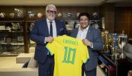 Brazilian Football Confederation President Ednaldo Rodrigues (right) presents a jersey to Sport Integrity Global Alliance SIGA CEO Emanuel Macedo de Medeiros.