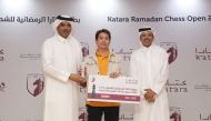 Katara officials handing over the award to one of the winners.