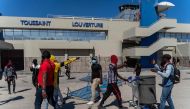 (FILES) Demonstrators break into the Toussaint Louverture International Airport to protest the recent killings of six police officers by armed gangs, in Port-au-Prince, Haiti, January 26, 2023. (Photo by Richard Pierrin / AFP)
