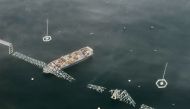 A view of the Singapore-flagged container vessel Dali and the collapse of Francis Scott Key Bridge. Photo by Carolyn Van Houten / The Washington Post. 