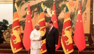 photograph released by Sri Lanka Prime Minister's Office on March 27, 2024 shows Sri Lanka's Prime Minister Dinesh Gunawardena (L) shaking hands with China's President Xi Jinping before a meeting in Beijing. Photo by Sri Lanka Prime Minister's Office / AFP. 