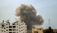 Smoke rises above buildings during an Israeli strike in the vicinity of the al-Shifa hospital in Gaza City on March 28, 2024. (Photo by AFP)