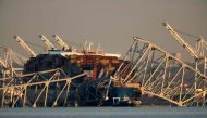 The cargo ship Dali remains trapped under the twisted remains of the Francis Scott Key Bridge, which was destroyed when the ship collided with it earlier this week, on March 29, 2024 in Baltimore, Maryland. Photo by CHIP SOMODEVILLA / GETTY IMAGES NORTH AMERICA / Getty Images via AFP