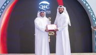 Group Chief Administrative Officer of QIC Group, Rashid Al Buainain honouring a long serving employee during the ceremony.
