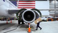An employee of Jet Blue airlines walks around an engine of an Airbus A320 passenger aircraft in a maintenance hangar of the company at JFK International Airport in New York on March 4, 2024. Photo by Charly TRIBALLEAU / AFP