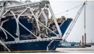 This handout photo obtained from the US Coast Guard on March 31, 2024 shows a portion of of the collapsed Francis Scott Key Bridge resting upon the container ship Dali in the Patapsco River, in Baltimore, Maryland, on March 30, 2024. Photo by Kimberly REAVES / US COAST GUARD / AFP
