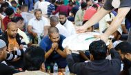 People gather for Iftar meal at a tent arranged by the Ministry of Awqaf and Islamic Affairs.
