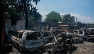 The charred remains of vehicles that were burned near a garage are seen in Port-au-Prince, Haiti, on March 25, 2024. (Photo by Clarens Siffroy / AFP)