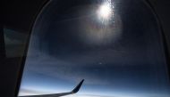 Dark skies can be seen out of the window of Delta flight 1010 on Monday. Pic: Jabin Botsford/The Washington Post