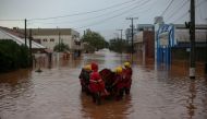 A team of firefighters work at a flooded street in the city center of Sao Sebastiao do Cai, Rio Grande do Sul state, Brazil on May 2, 2024. Photo by Anselmo Cunha / AFP