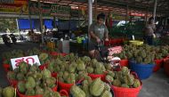 This photo taken on May 1, 2024 shows baskets of durians for sale at Wat Si Muang temple in Thailand's eastern Chanthaburi province. (Photo by Lillian Suwanrumpha / AFP) 