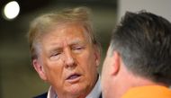 Donald Trump and McLaren Chief Executive Officer Zak Brown talk in the McLaren garage prior to the F1 Grand Prix of Miami at Miami International Autodrome on May 05, 2024 in Miami, Florida. (Photo by CLIVE MASON / GETTY IMAGES NORTH AMERICA / Getty Images via AFP)
