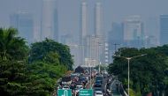 This photo shows a general view of a traffic jam on a main roads leading into the city center of Jakarta on May 8, 2024 as thin haze of pollution sits over the city's skyline. (Photo by BAY ISMOYO / AFP)
