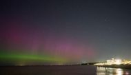 The Northern lights or aurora borealis illuminate the night sky in Grand Bend, Ontario, Canada, during a geomagnetic storm on May 12, 2024. Photo by Geoff Robins / AFP