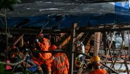 National Disaster Response Force (NDRF) personnel look for survivors during a rescue operation at the site where an advertisement hoarding collapsed on a fuel station after a dust storm in Mumbai on May 13, 2024. (Photo by Punit PARANJPE / AFP)
