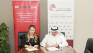 Ali Saeed Bu Sherbak Al Mansouri, Acting General Manager of Qatar Chamber, and Vanessa Rameix, Country Director for The Business Year in Qatar during the MoU signing.