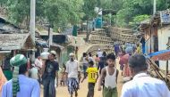 This photo taken on May 24, 2024 shows Rohingya refugees walking down a path at a Rohingya refugee camp in Ukhia in Bangladesh's southeastern Cox's Bazar district. (Photo by AFP) 