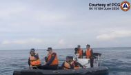 This handout photo grabbed from a video released by the Philippine Coast Guard on June 7, 2024 shows Chinese Coast Guard personnel aboard their rigid inflatable boat, blocking a Philippine Coast Guard rigid inflatable boat carrying marine scientists in the waters of the South China Sea. Photo by Mahmoud RIZK / Philippine Coast Guard (PCG) / AFP