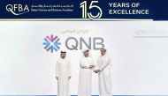 QNB officials with a Qatari graduate during 'Kawader Malia 2024' ceremony.