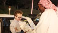 A kid receives a gift during the Eid celebration at the Katara Cultural Village yesterday.