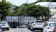 French gendarmes stand guard at a roadblock outside the courthouse, where eleven independentists, including one of the leaders of the pro-independence CCAT movement, face court for their involvement in last month's spate of deadly unrest, in Noumea in the French Pacific territory of New Caledonia on June 22, 2024. Photo by Theo Rouby / AFP.