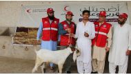 QRCS representatives with a beneficiary of Adahi Project in Pakistan.